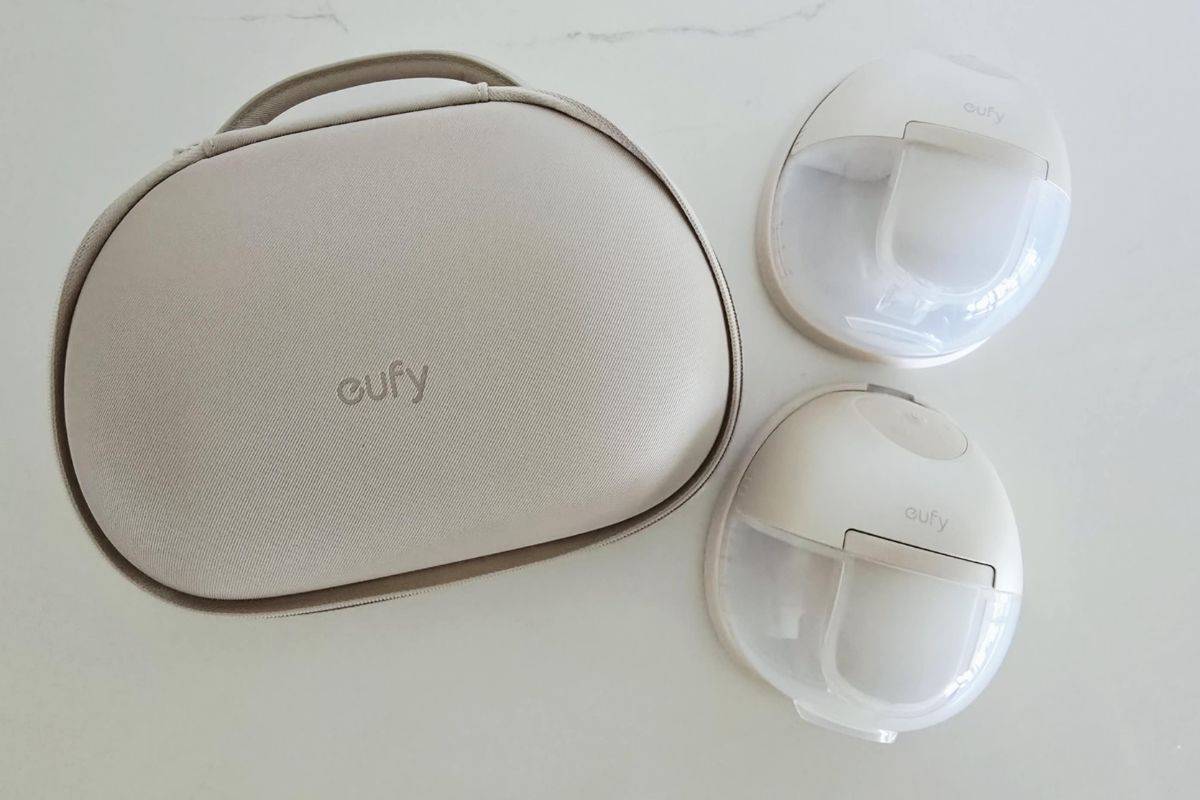 Two Eufy S1 Pro wearable breast pumps displayed next to the beige Eufy rechargeable carry case on a white surface.